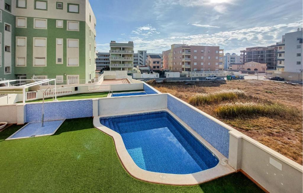a swimming pool on the roof of a building at Nice Apartment In Moncofa Playa With Outdoor Swimming Pool in Moncófar