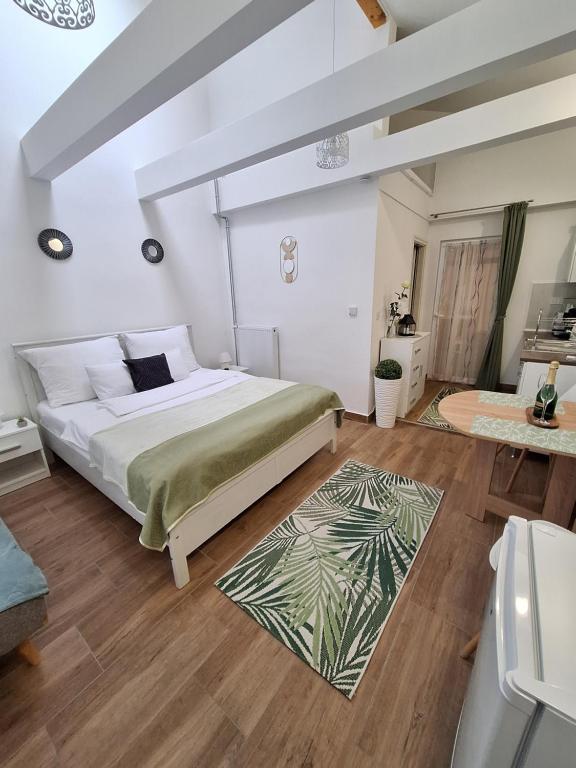 a bedroom with a large bed and a rug at Várfal apartman II in Eger
