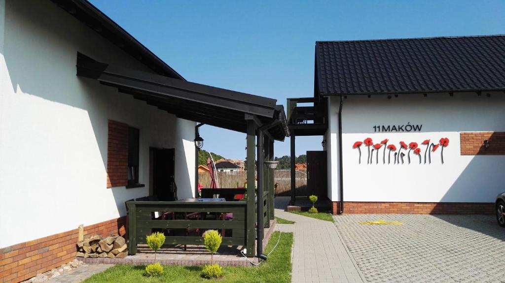 a building with a table and a sign on it at 11 Maków in Mielenko