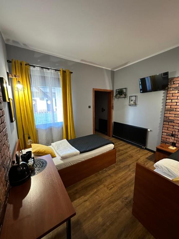 ein Schlafzimmer mit einem Bett und einem Tisch in einem Zimmer in der Unterkunft Hotel Nenufar Premium in Kościan