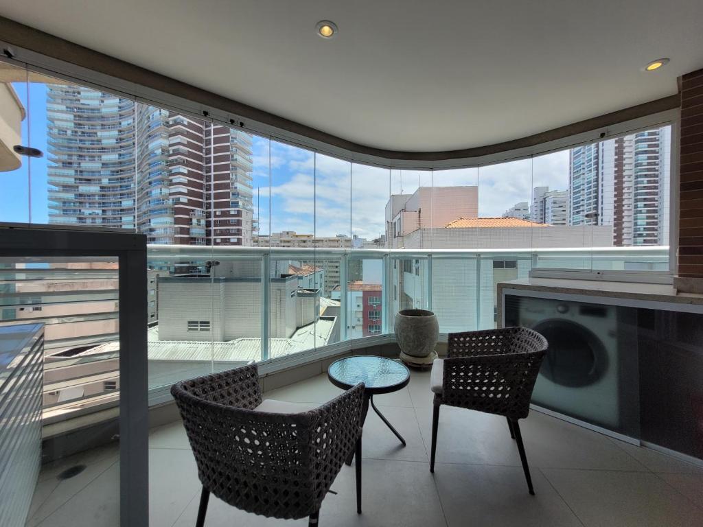 a living room with a table and two chairs at Book Santos - Estanconfor 1201 - Conforto e comodidade na quadra da Praia in Santos