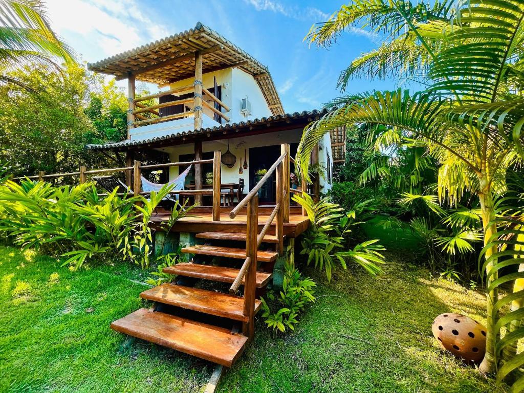 una casa con scala in legno che la porta di Casa com piscina e vista para a Praia do Espelho a Porto Seguro