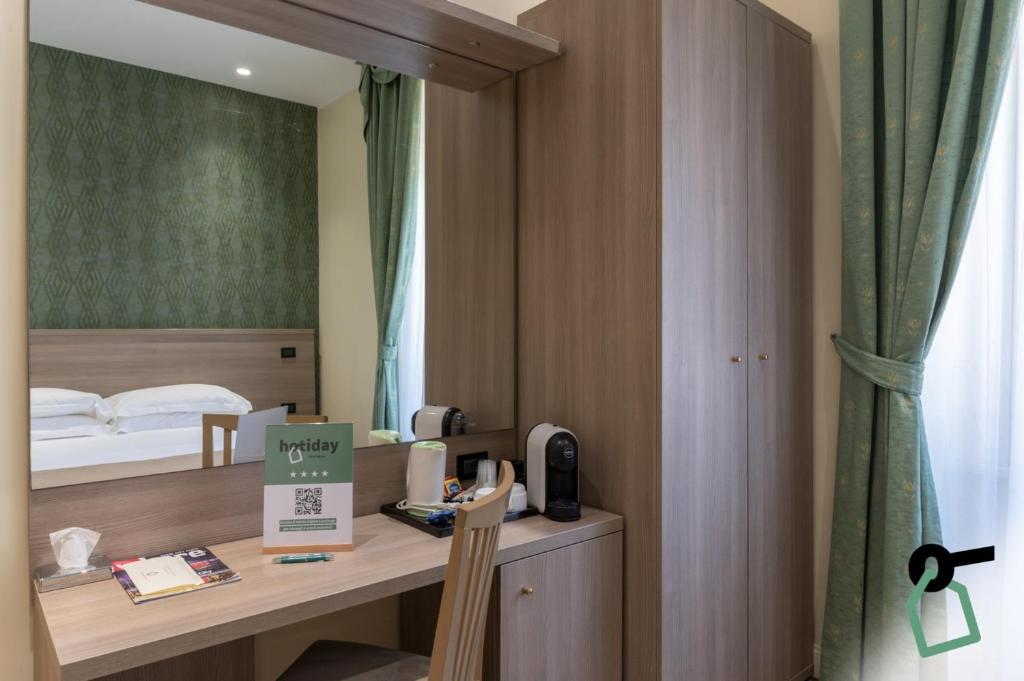 Postel nebo postele na pokoji v ubytování HOTIDAY Room Collection - Roma Porta Pia
