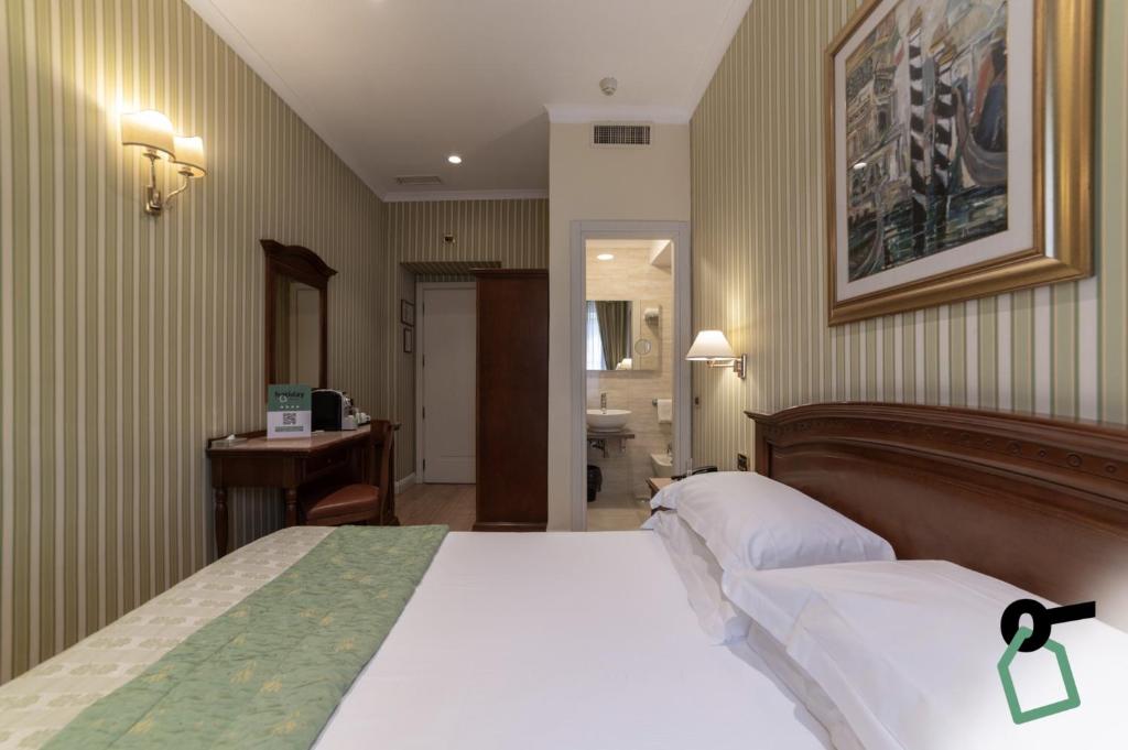 Postel nebo postele na pokoji v ubytování HOTIDAY Room Collection - Roma Porta Pia