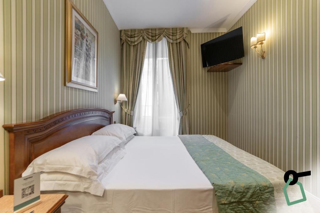 Postel nebo postele na pokoji v ubytování HOTIDAY Room Collection - Roma Porta Pia