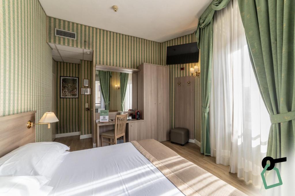 Postel nebo postele na pokoji v ubytování HOTIDAY Room Collection - Roma Porta Pia