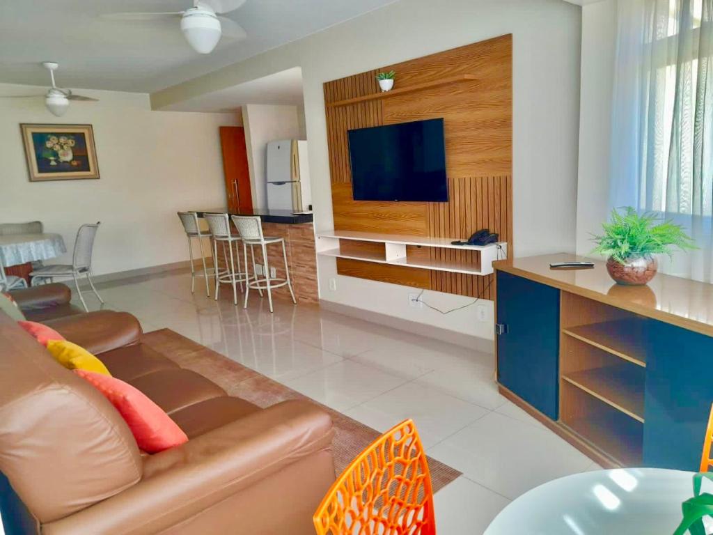 uma sala de estar com um sofá e uma TV de tela plana em Parque das Águas Quentes em Caldas Novas