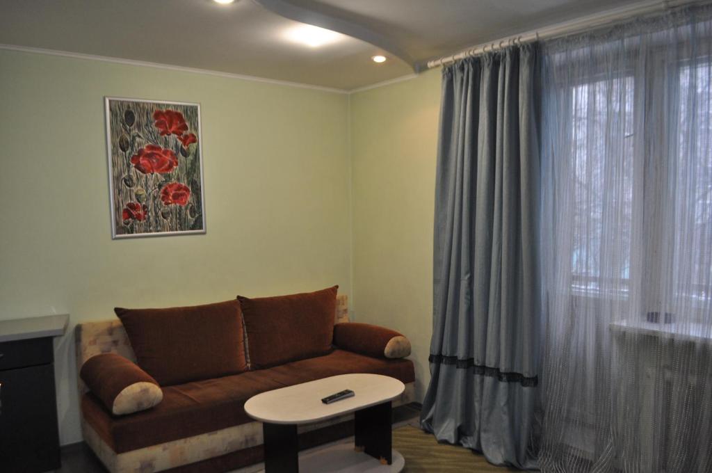 a living room with a couch and a window at DayFlat Apartments Kremenchug in Kremenchuk