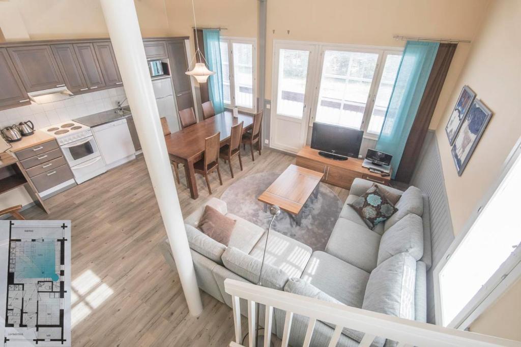 an overhead view of a living room and kitchen with a couch at Levillenet Glacier Alpine Chalets at Levi Centre in Levi