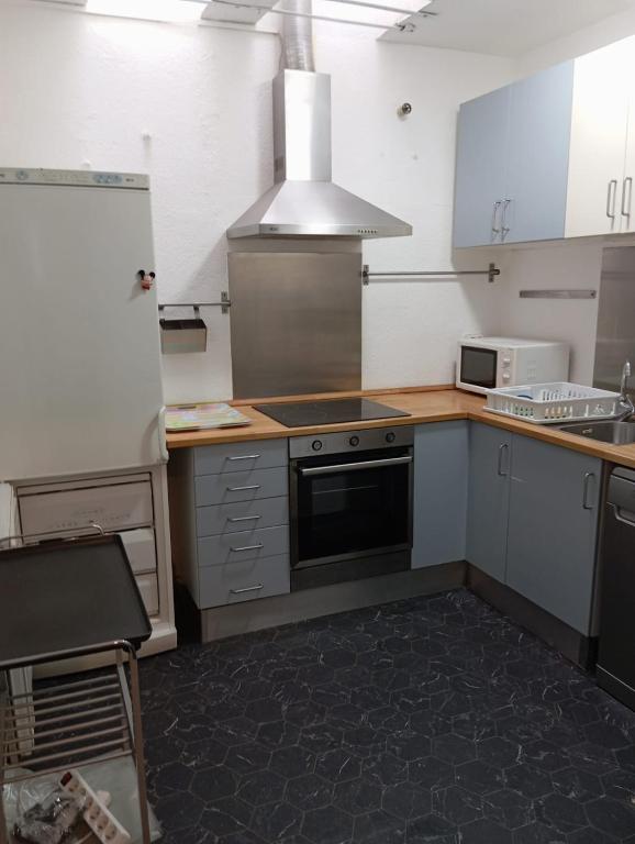 a kitchen with a sink and a stove top oven at La playa in L'Escala