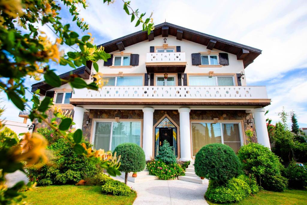 a large white house with a front yard at Villa Loreto in Shagan