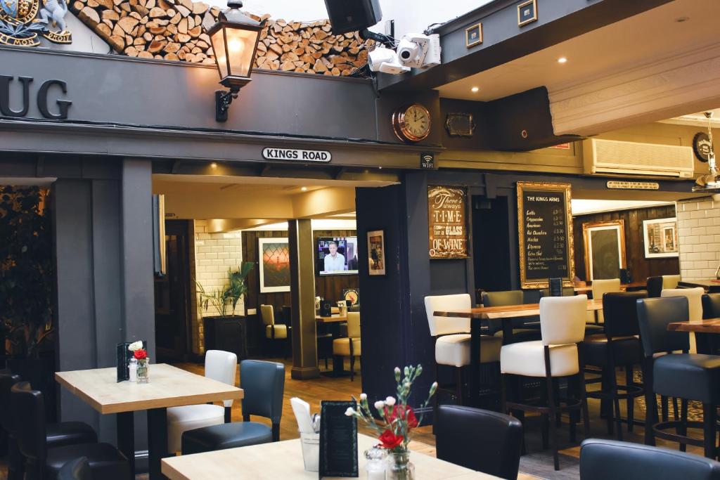 a restaurant with tables and chairs in front of it at The Kings Arms in Swindon