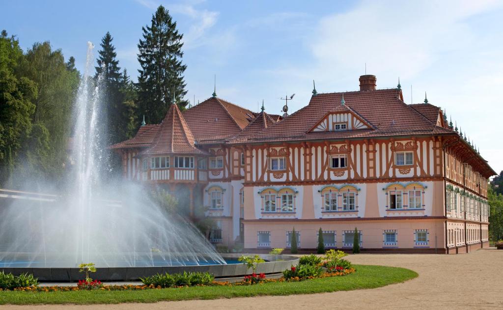 a water fountain in front of a large building at Jurkovičův dům in Luhačovice