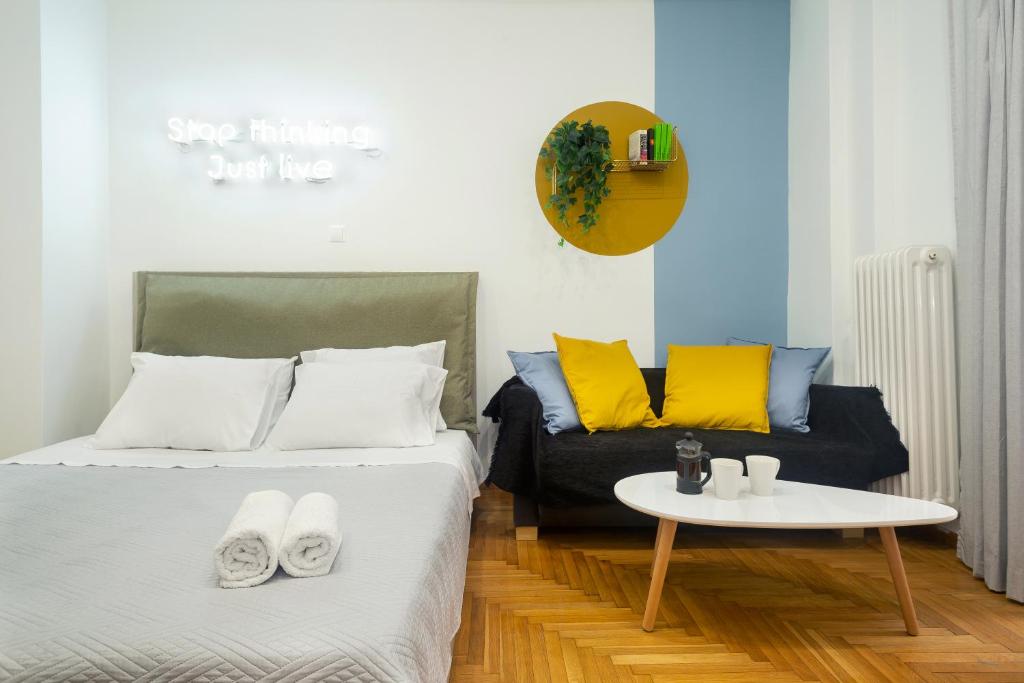 a bedroom with a bed and a table and a couch at KUKAKI ESTATE 1 in Athens