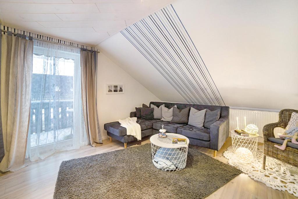 a living room with a couch and a large window at Haus Ruth in Hörden