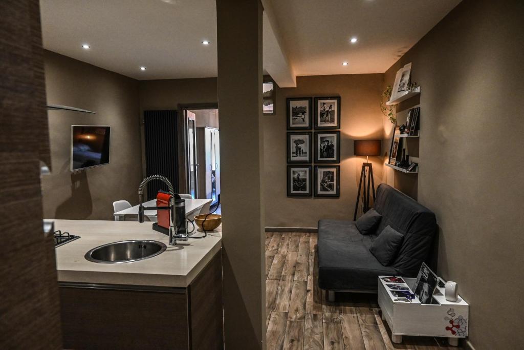 a bathroom with a sink and a couch in a room at Casa Via Po in Turin