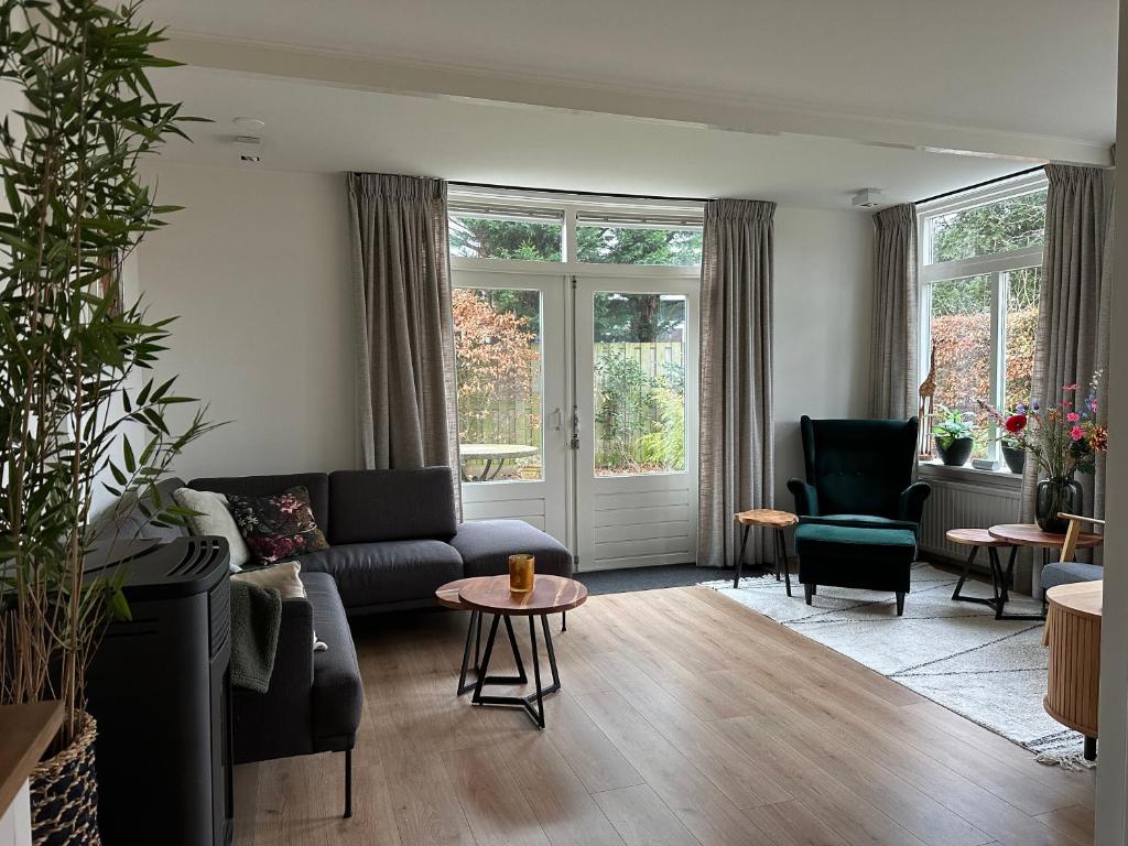 a living room with a couch and a table at De Lijster in Bergen