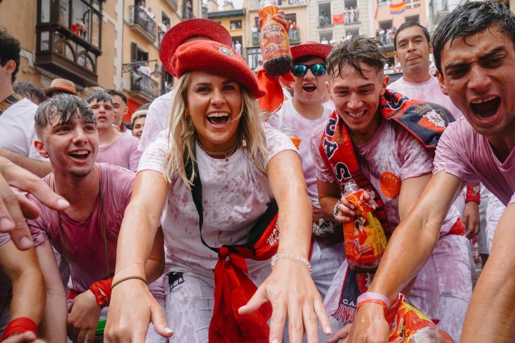 a group of people dressed up in pink paint at Running of the Bulls All inclusive Camping Pamplona in Pamplona