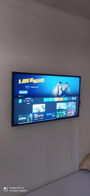 a flat screen tv hanging on a wall at Mini Casa em Arraial d'Ajuda in Porto Seguro