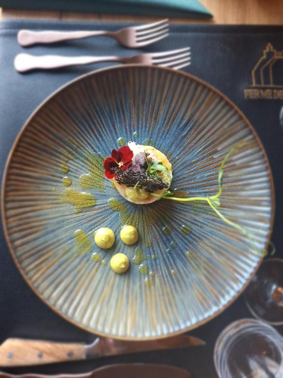 a glass plate with a dessert on top of it at Ferme Delgueule in Tournai