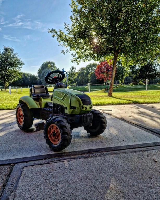 a four wheeled vehicle parked on the street at Ferme Delgueule in Tournai