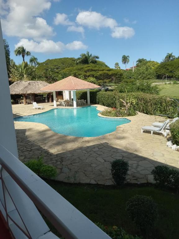 a view of the pool from the balcony of a resort at Tropical Optimal Tropicana Sur in Sosúa