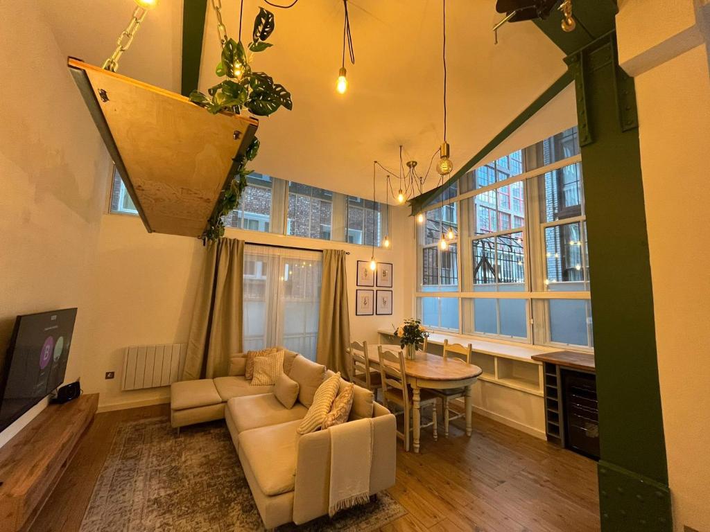 a living room with a couch and a table at City Centre Loft Apartment in Stalybridge