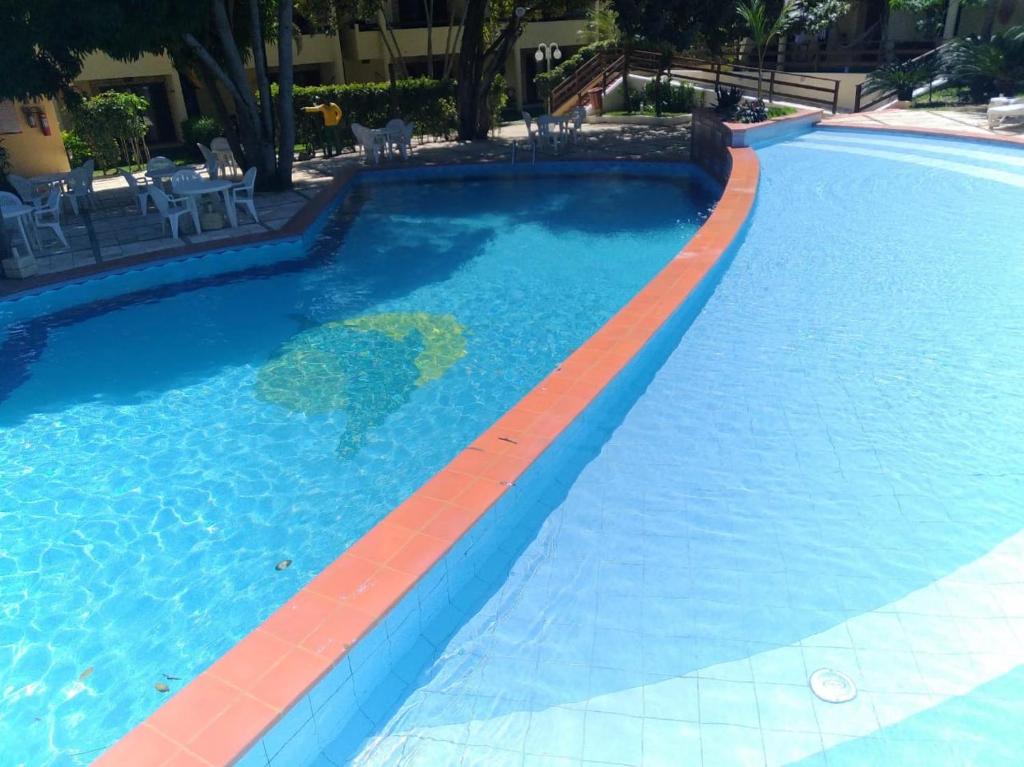 a swimming pool with a red stripe in the water at Solar pipa duplex lua cheia in Pipa