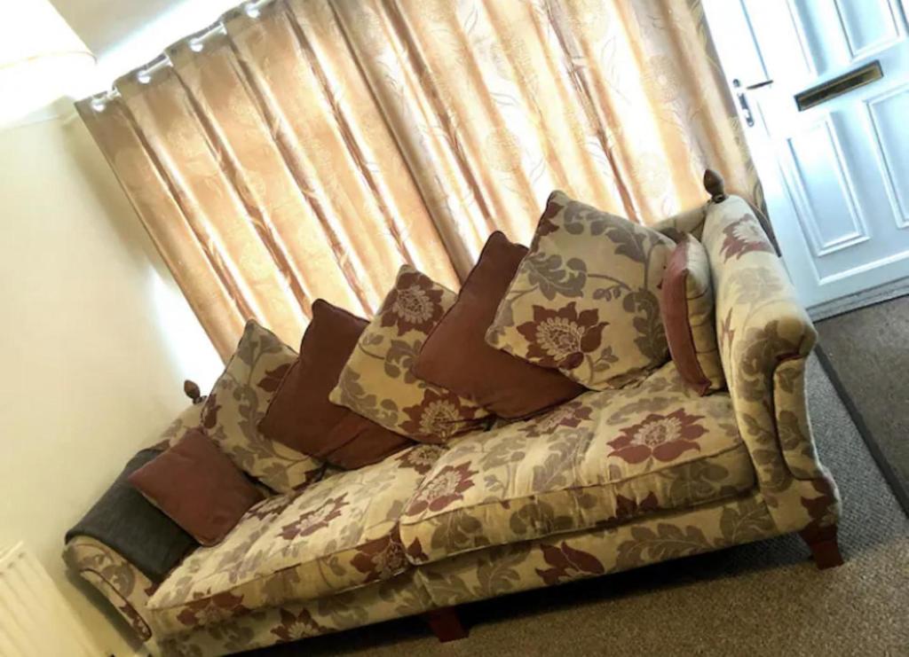 a couch with pillows sitting in front of a window at Ac lounge 115 1-Bed Apartment in Rochford in Rochford