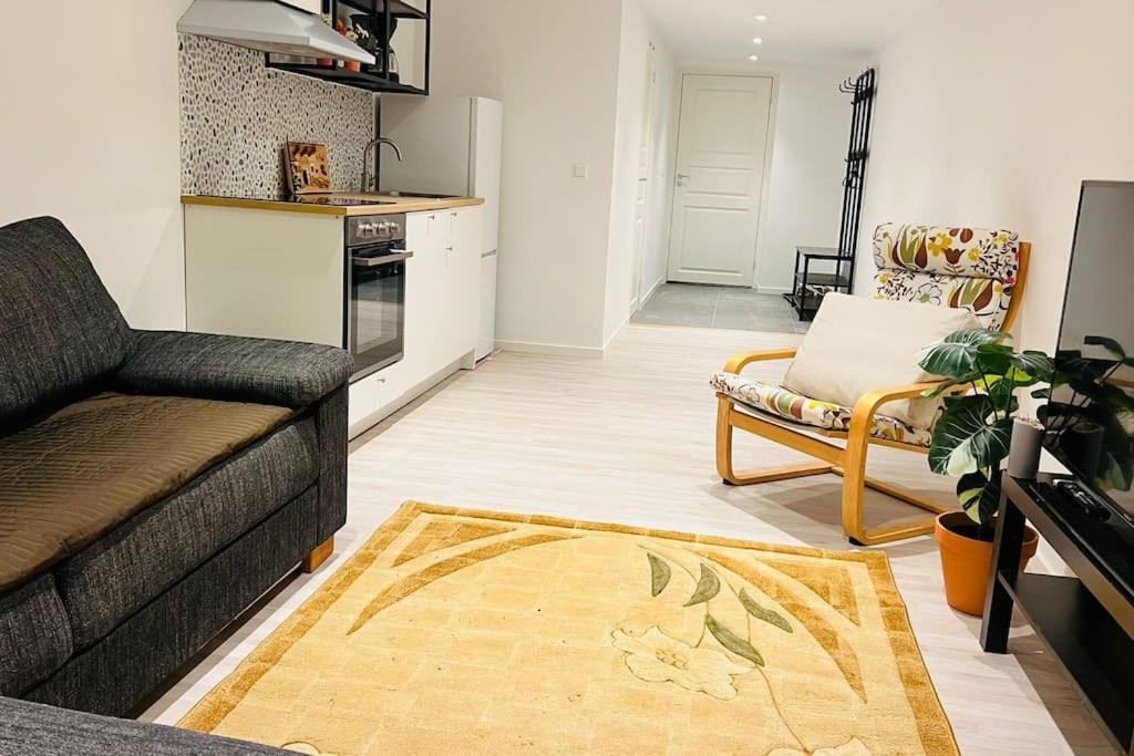 a living room with a couch and a kitchen at Newly built amazing apartment in Järfälla