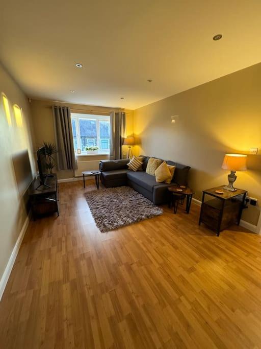 a living room with a couch and a table at Beautiful two bed home in Marsh in Lindley