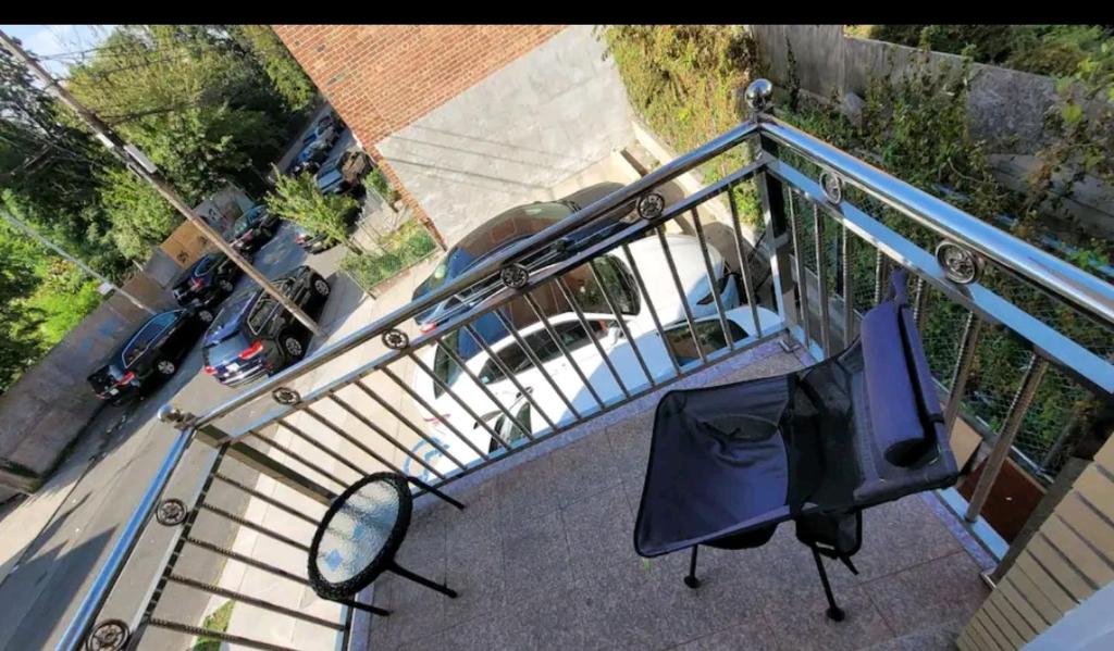 an overhead view of a balcony with a mirror and chairs at Comfortable rooms in NYC near the train in Woodside