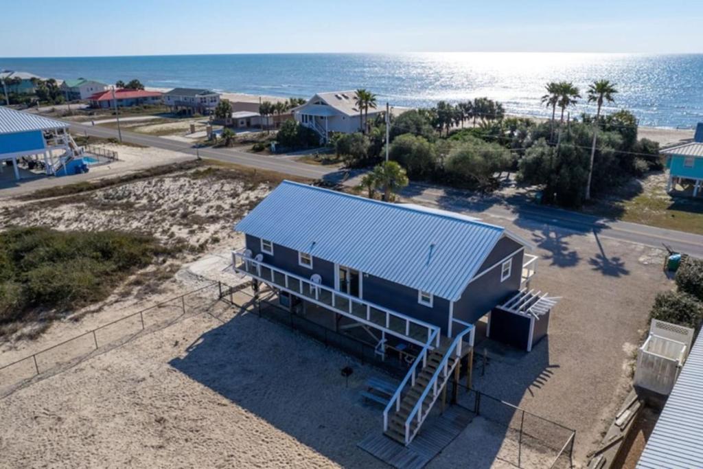 an aerial view of a blue house on the beach at The Blue Bungalow St. George Island in St. George Island