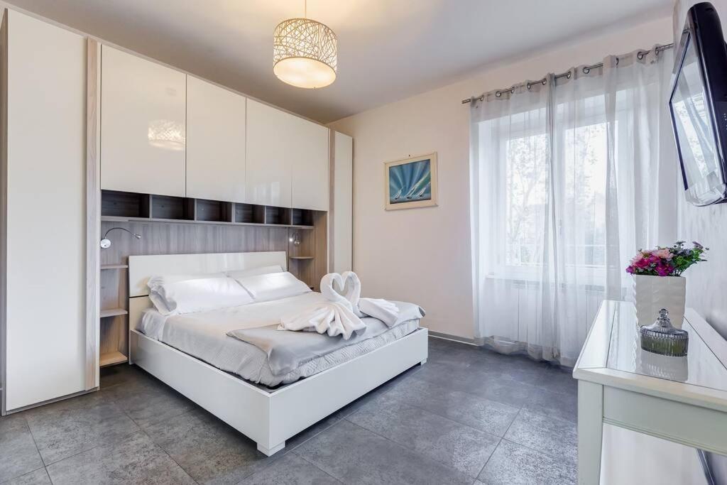 a bedroom with a white bed and a window at Domus In Roma Suite in Rome