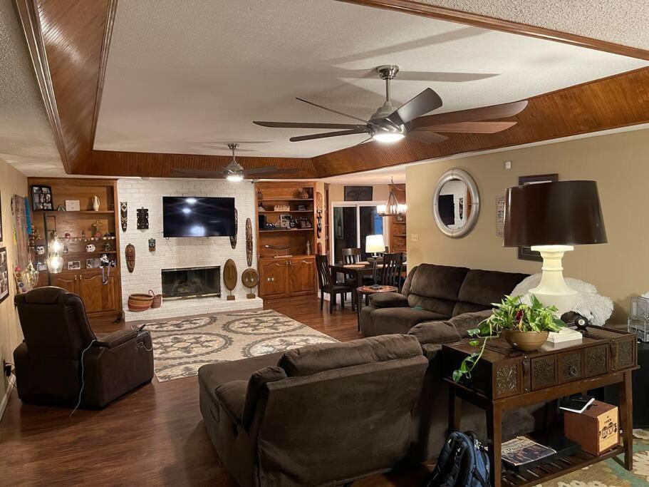 a living room with a couch and a ceiling fan at Three Bedroom Very Nice House - Bryant, AR in Bryant