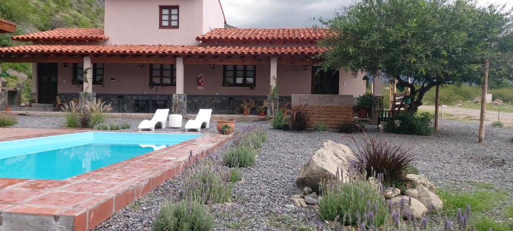 a house with a swimming pool in the yard at Las Piedritas Cafayate in Cafayate