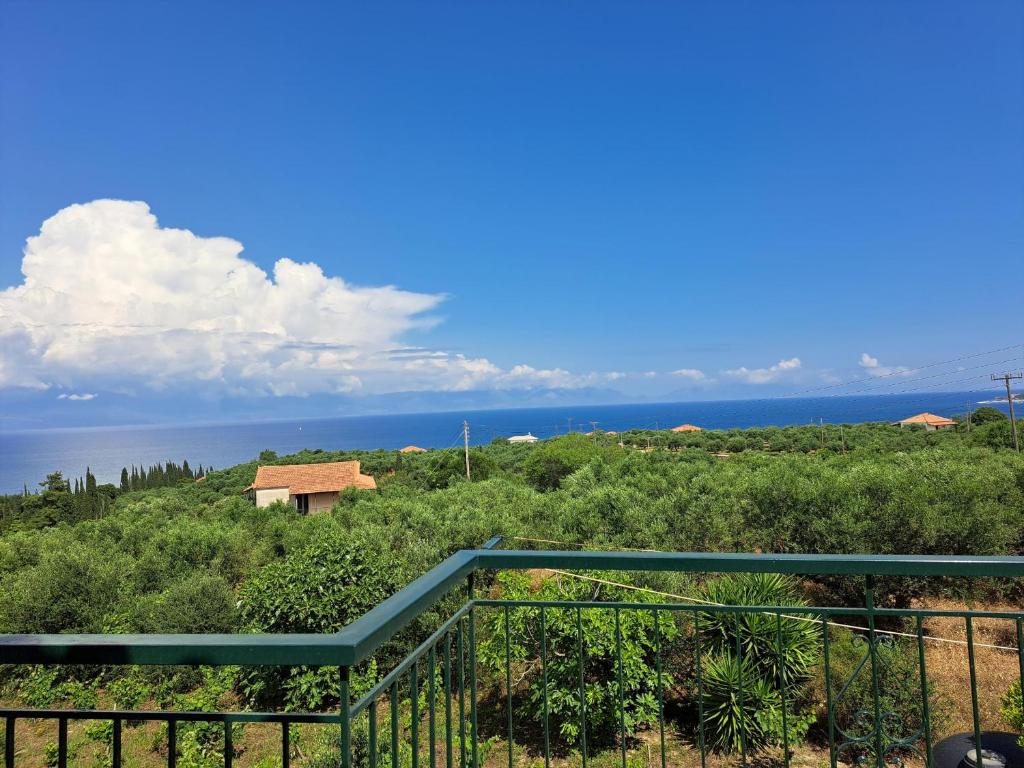 a view of the ocean from the balcony of a house at FILOXENIA Apartment 6 in Kómpoi