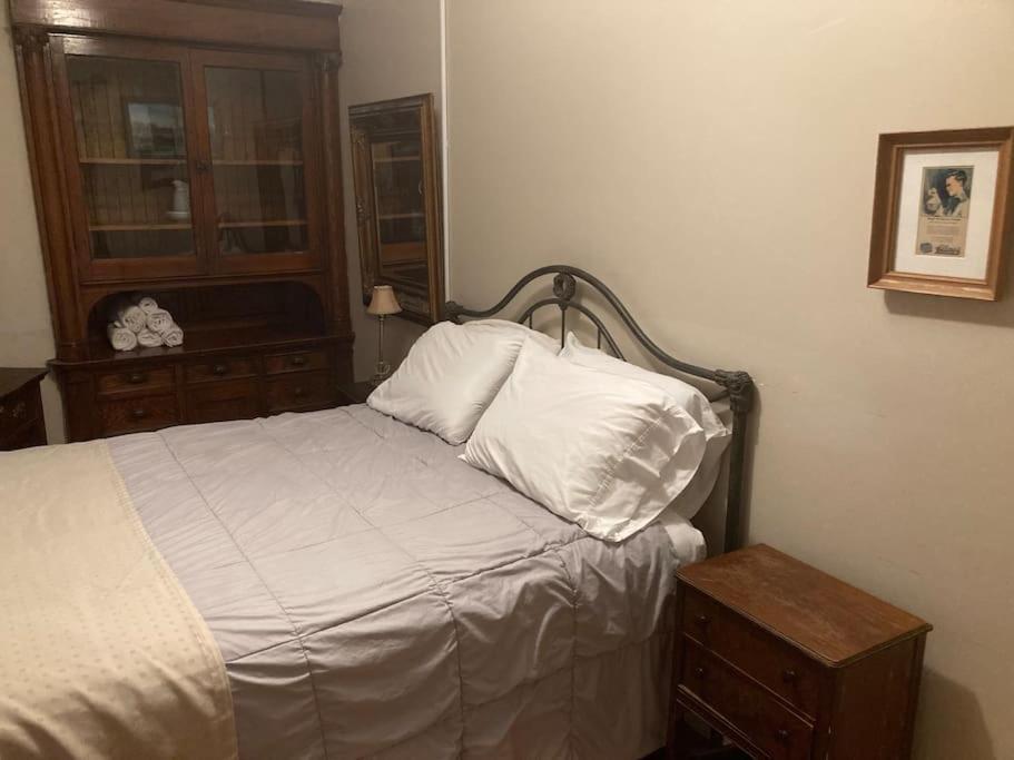 a bedroom with a bed with a night stand and a window at Queen Bed with Shared Bathroom in Lakeview - 2b in Chicago