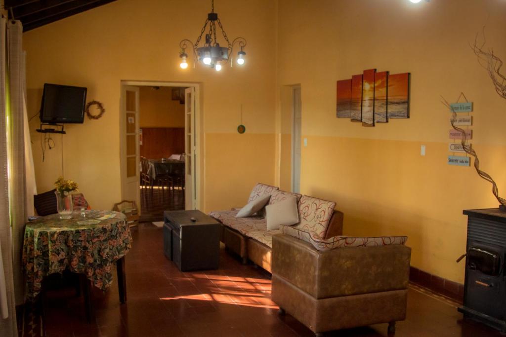 a living room with a couch and a table at Alma Alquimia in Valle Hermoso