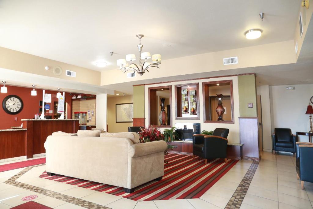 a lobby with a couch and a waiting room at Ramada by Wyndham Fresno Northwest in Fresno