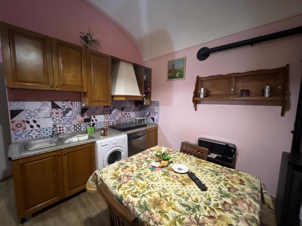 a small kitchen with a table and a stove at Corona Grossa - due posti letto - B in Brusasco