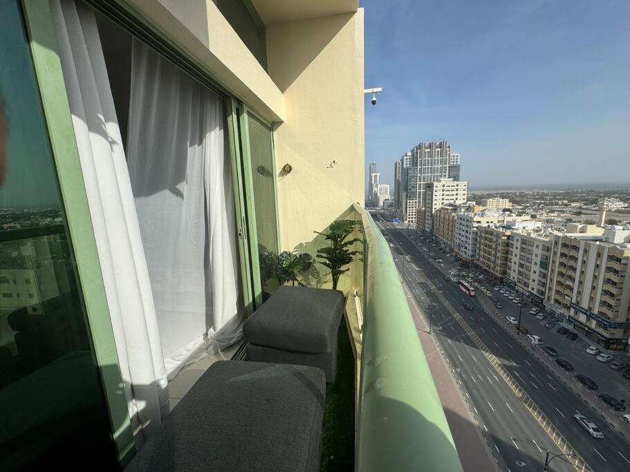 a balcony of a building with a view of a city at Studio in Fujairah,CIT&SEA view in Fujairah