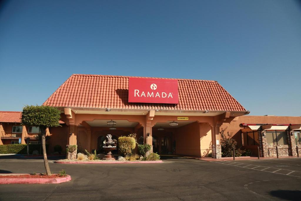 a rambala building with a sign on top of it at Ramada by Wyndham Fresno North in Fresno