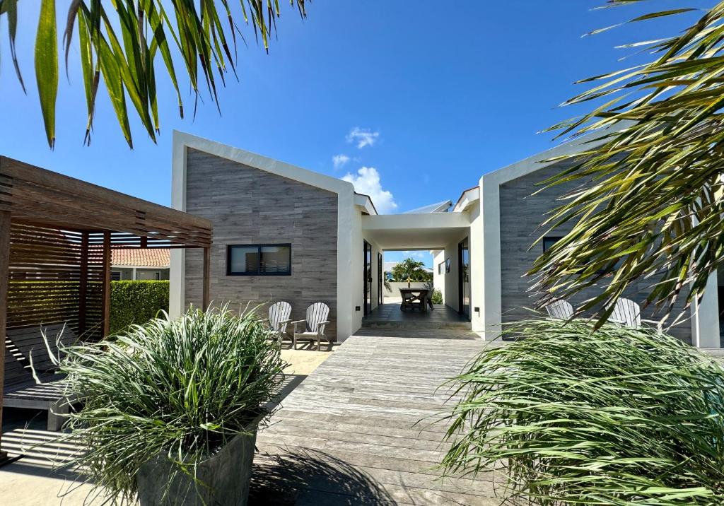 a house with a wooden walkway to the front yard at Salt Apartments Bonaire in Kralendijk