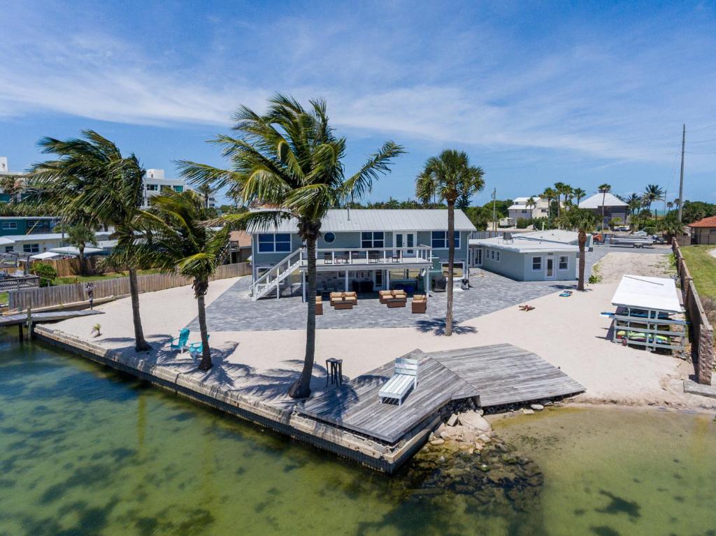 an aerial view of a house with a dock in the water at Banana River Resort in Cocoa Beach