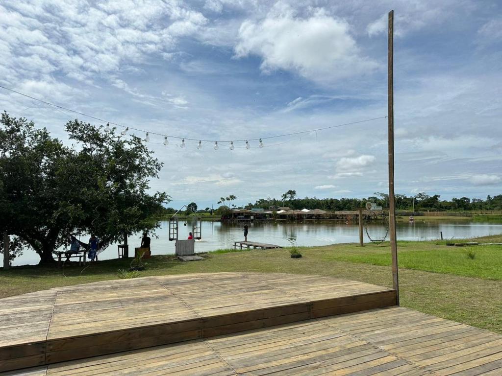 a wooden deck with a view of a body of water at Espaço Leão Eventos in Rio Branco