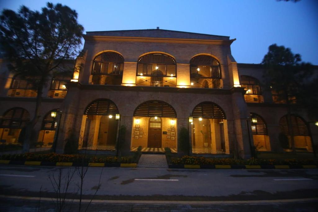 a large building with lights on it at night at Peshawar Barracks in Peshawar