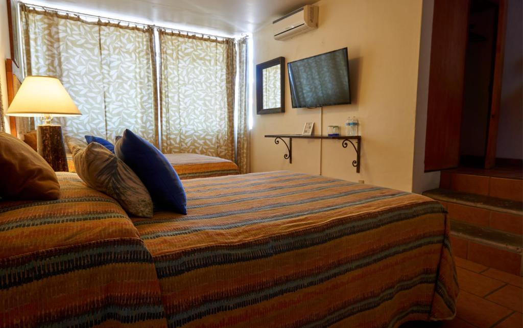 Postel nebo postele na pokoji v ubytování Casa Tlaquepaque