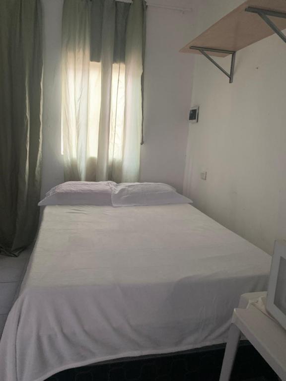 Postel nebo postele na pokoji v ubytování Kitinete Aconchegante