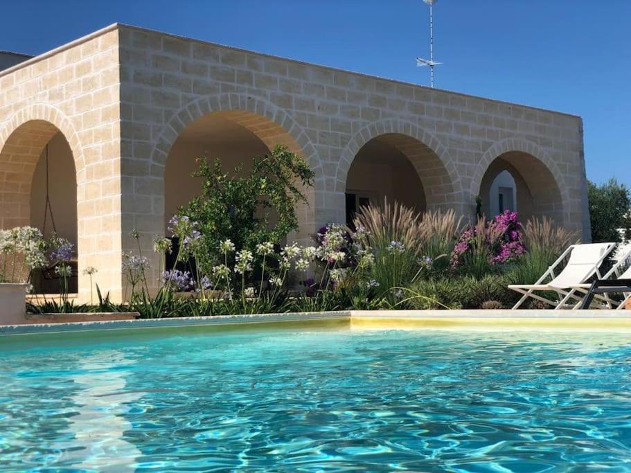 a swimming pool in front of a house at LàMìa Donnagnora in Ostuni